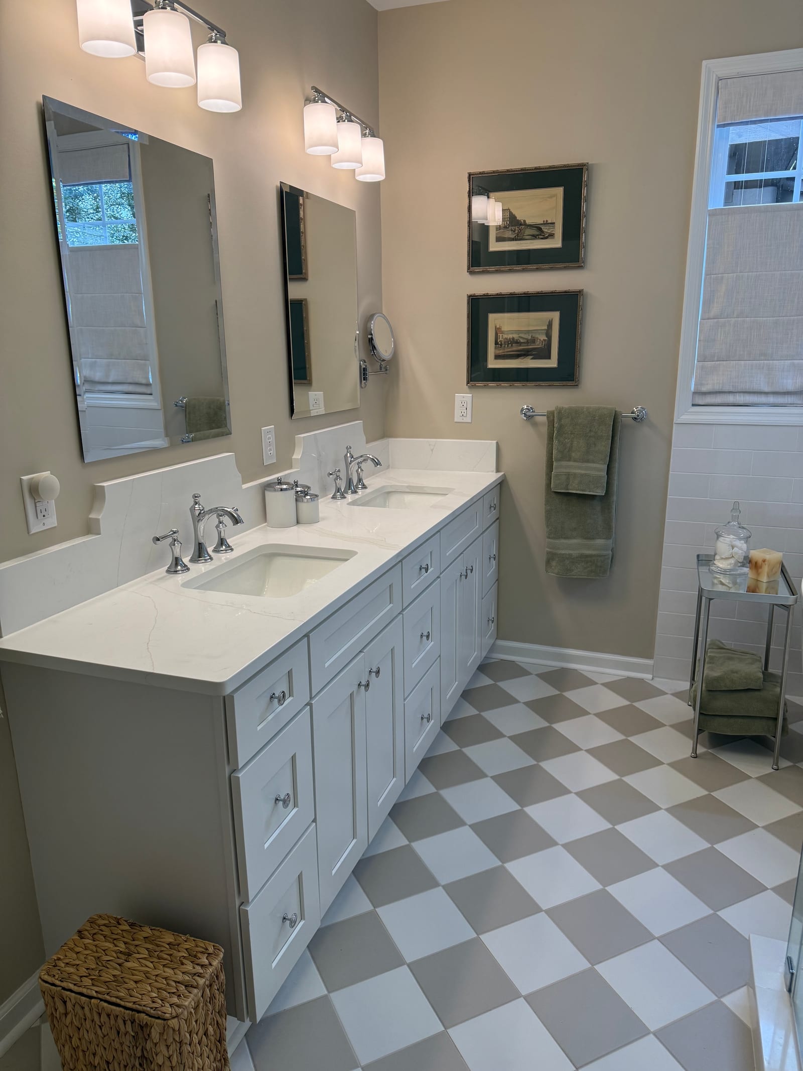 Double vanity with a quartz top and two undermount basins, framed mirrors above and checkerboard tile flooring